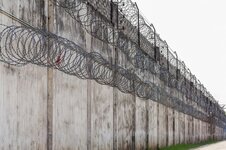 prison-walls-fence-with-barbed-wire_39791-65.jpg