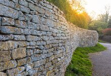 cotswolds-stone-fence-shown-leading-perspective-sun-flar-old-traditional-wall-flare-91526994.jpg